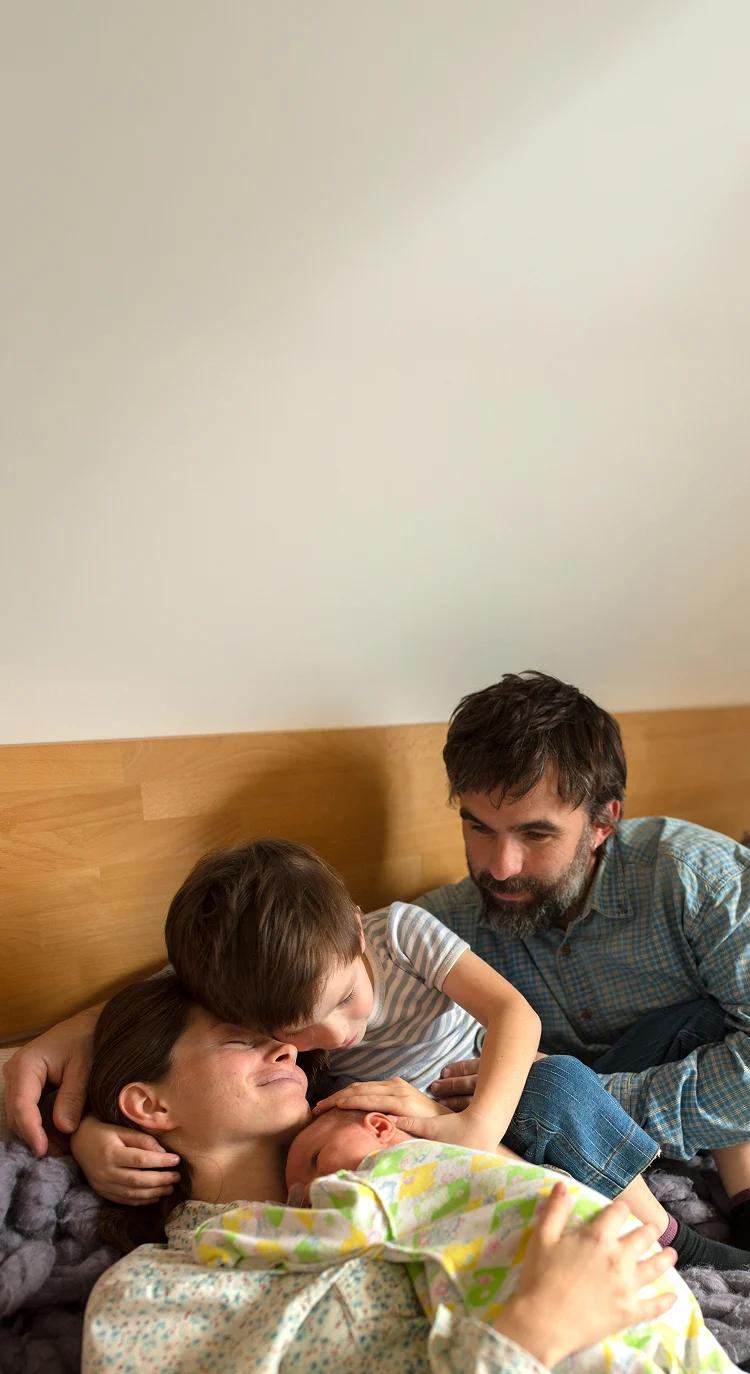 Parents cuddling their toddler