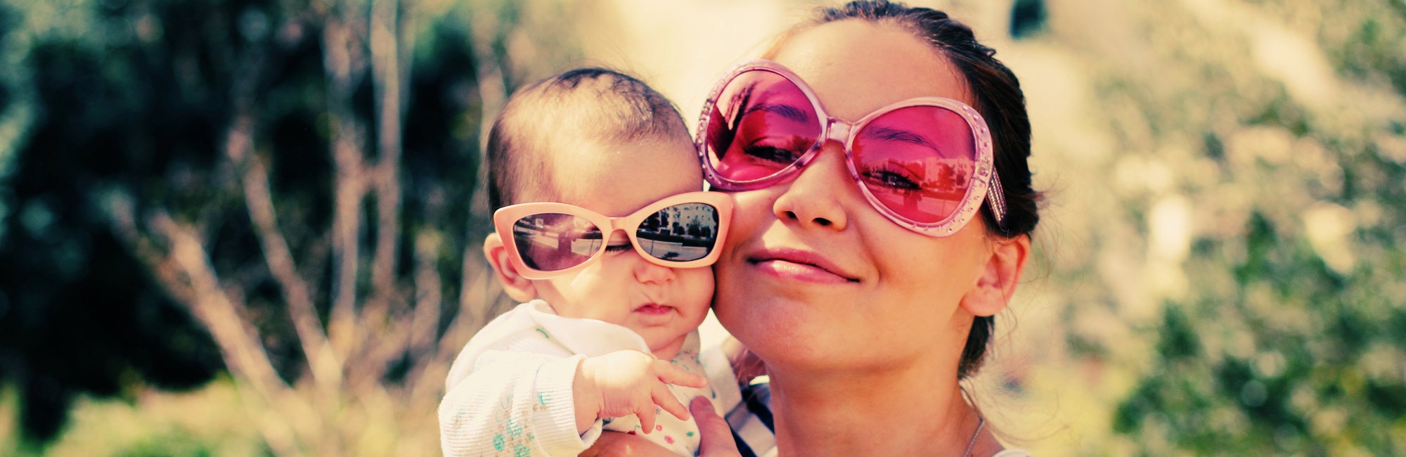 mother and baby outside wearing bright sunglasses