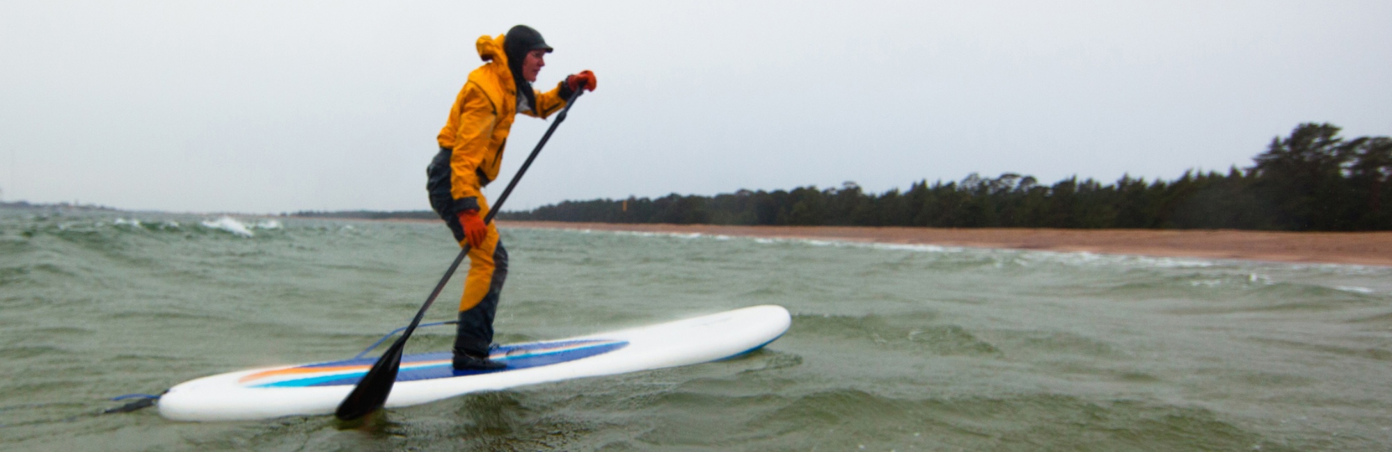 stand up paddle boarder in ocean