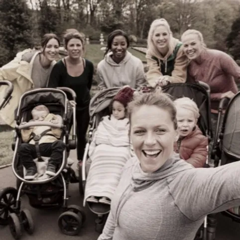 Mothers and babies walking outside with prams