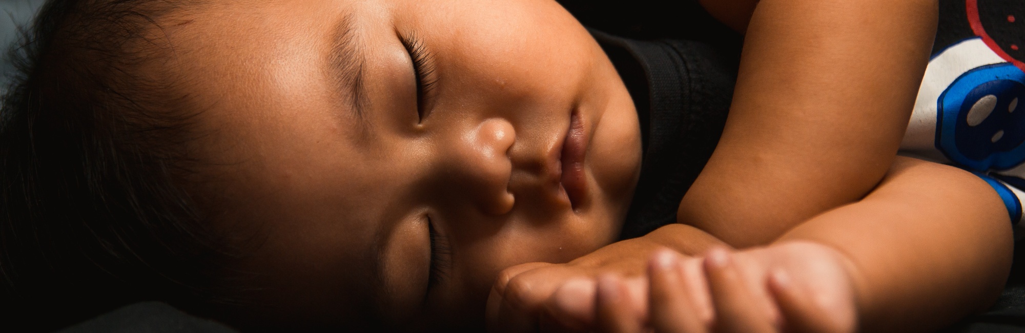 brown skinned baby sleeping peacefully