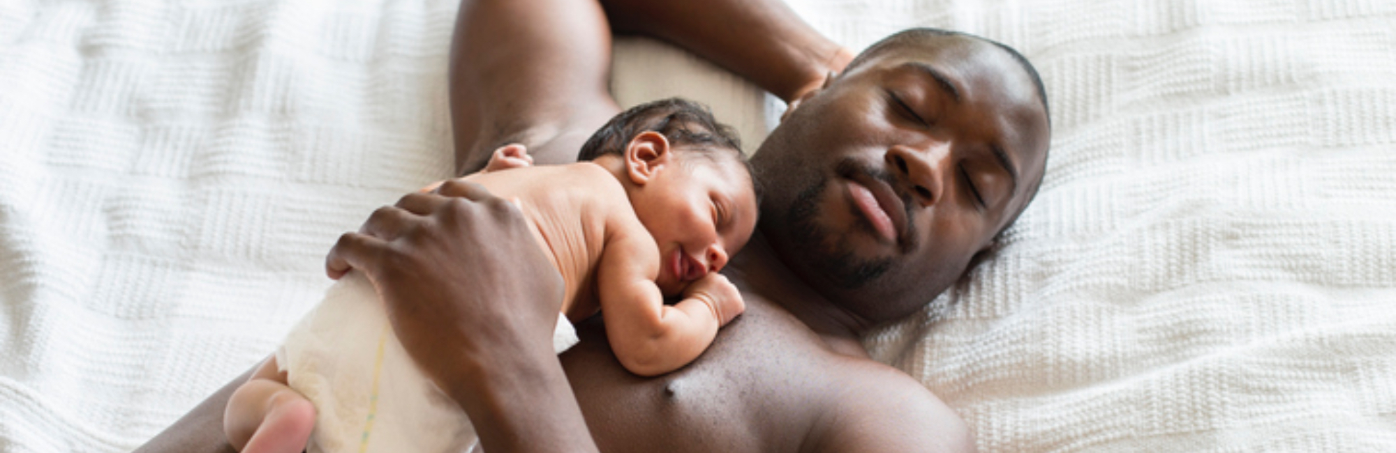 Baby sleeping on father's chest