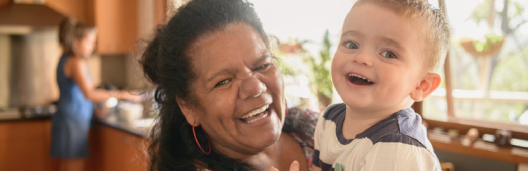 first nations lady smiling with young toddler