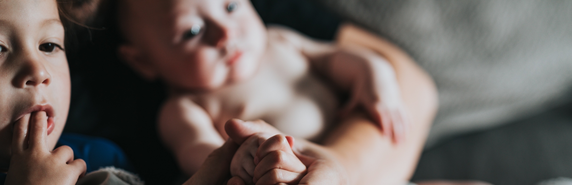 baby and a toddler sitting next to each other