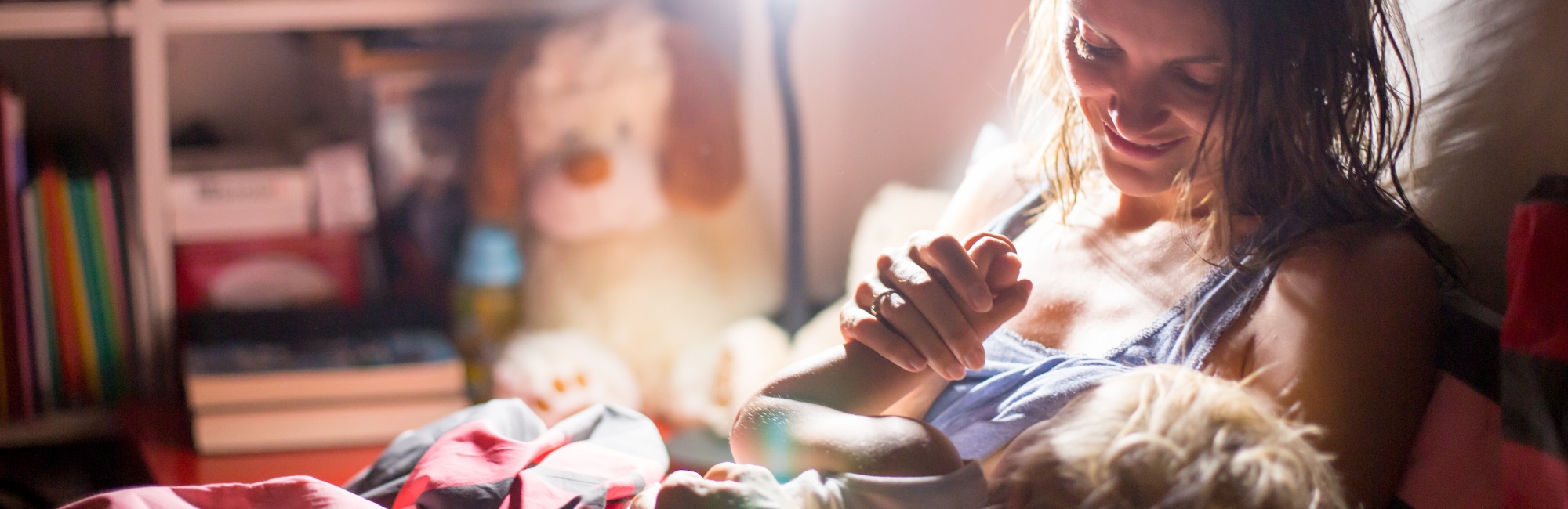 mother breastfeeds toddler at night