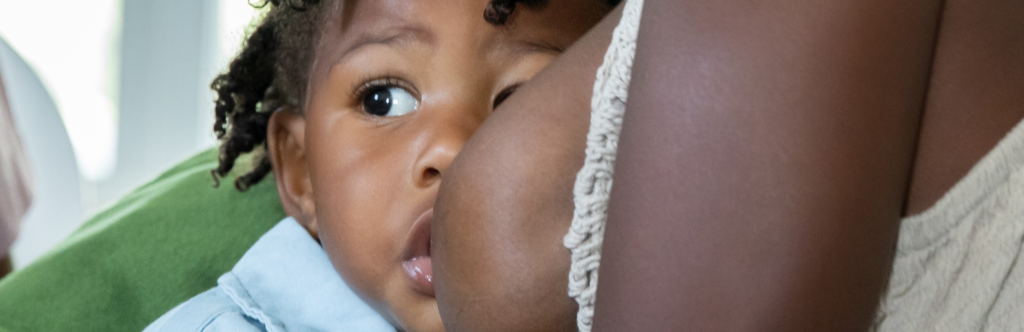 dark skinned toddler breastfeeds