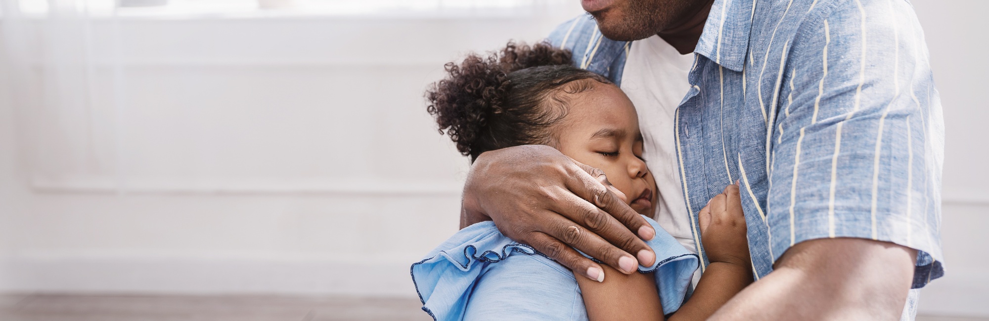 father hugs his young child
