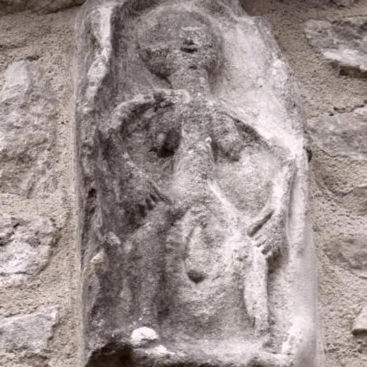 Ancient birthing woman carving
