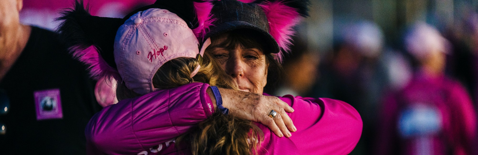 mother and adult daughter hug at end of race